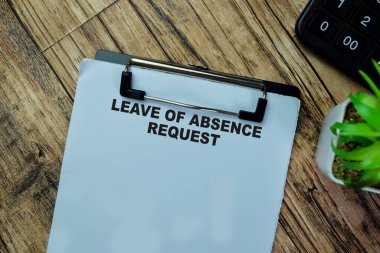 Concept of Leave of Absence Request write on paperwork isolated on Wooden Table.
