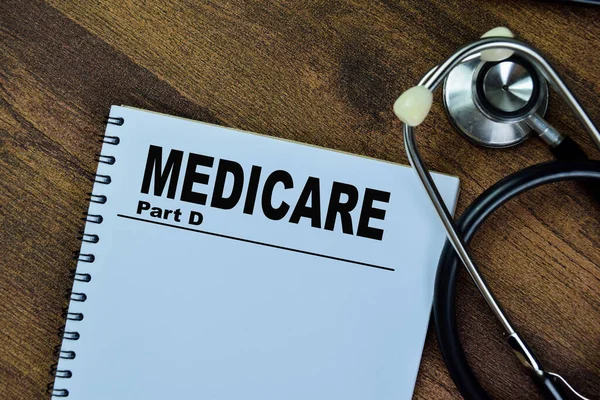 stock image Concept of Medicare Part D write on book with stethoscope isolated on Wooden Table.