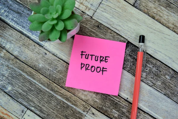 Concept of Future Proof write on sticky notes isolated on Wooden Table.