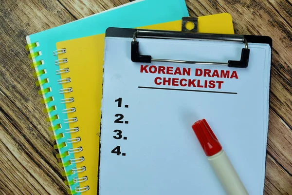 Concept of Korean Drama Checklist, Supported by an additional services write on paperwork isolated on Wooden Table.
