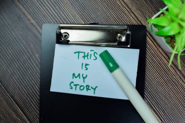 Concept of This is My Story write on sticky notes isolated on Wooden Table. clipart