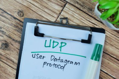 Concept of UDP - User Datagram Protocol write on paperwork isolated on Wooden Table. clipart