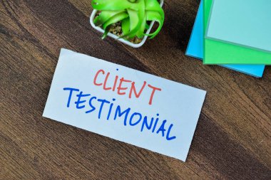 Concept of Client Testimonial write on sticky notes isolated on Wooden Table. clipart