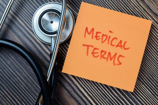 stock image Concept of Medical Terms write on sticky notes with stethoscope isolated on Wooden Table.