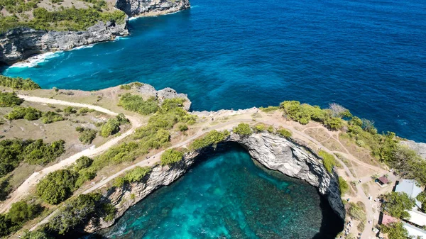 stock image Aerial view of a person along the whole sand beach coastline, Nusa Penida. Bali, Indonesia, July 20, 2023