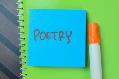 Concept of Poetry write on sticky notes isolated on Wooden Table. clipart