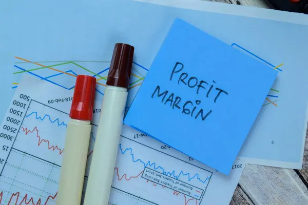 Concept of Profit Margin write on sticky notes isolated on Wooden Table.