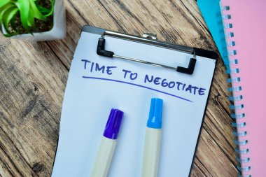 Concept of Time To Negotiate write on paperwork isolated on Wooden Table. clipart