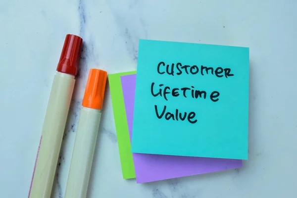Concept of Customer Lifetime Value write on sticky notes isolated on Wooden Table.