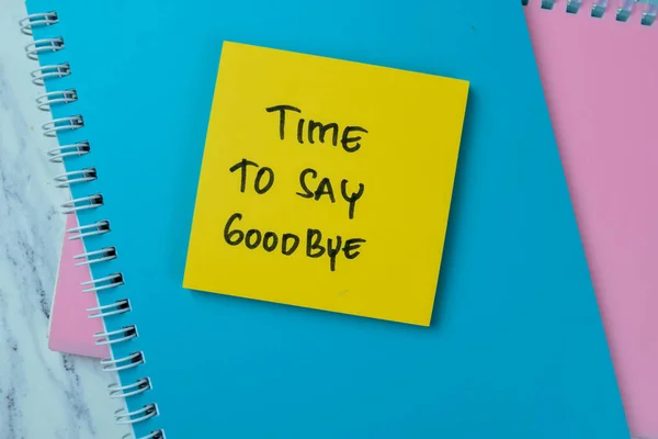 Concept of Time To Say GoodBye write on sticky notes isolated on Wooden Table.