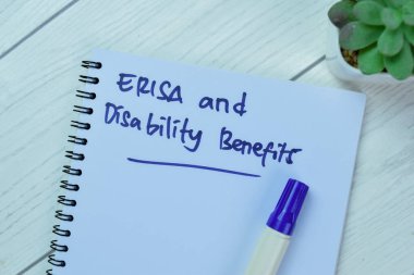 Concept of ERISA and Disability Benefits write on book isolated on Wooden Table. clipart