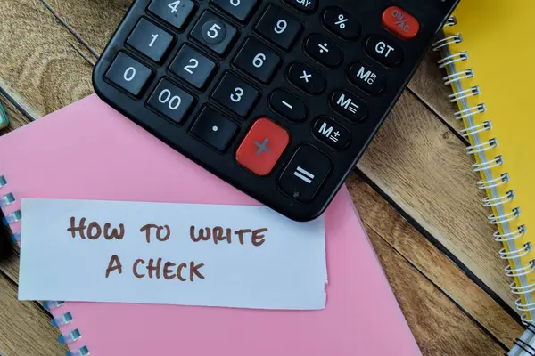 Concept of How To Write A Check write on sticky notes with stethoscope isolated on Wooden Table.