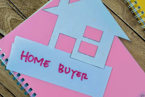 Concept of Home Buyer write on sticky notes isolated on Wooden Table.