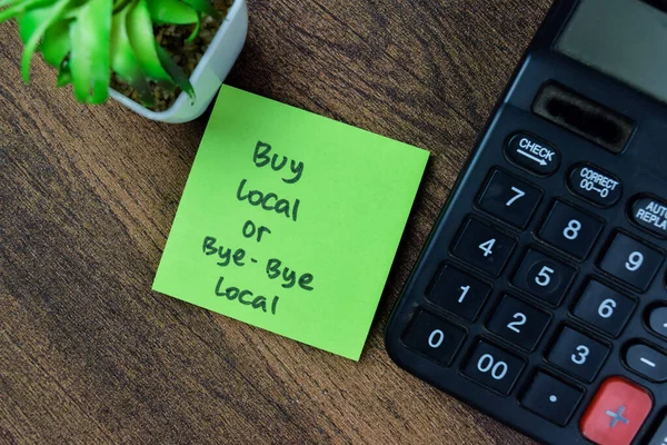 Concept of Buy Local or Bye-Bye Local write on sticky notes isolated on Wooden Table.