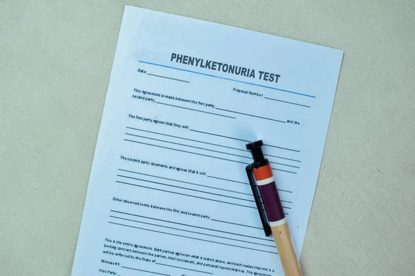 Concept of Form Phenylketonuria Test write on paperwork isolated on Wooden Table.