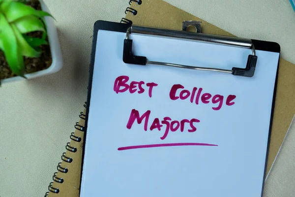 Concept of Best College Majors write on paperwork isolated on Wooden Table.