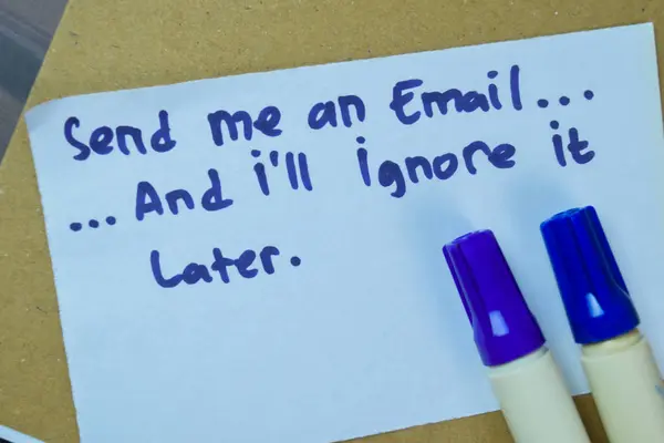 Concept of Send Me An Email, And I\'ll Ignore It Later write on sticky notes isolated on Wooden Table.