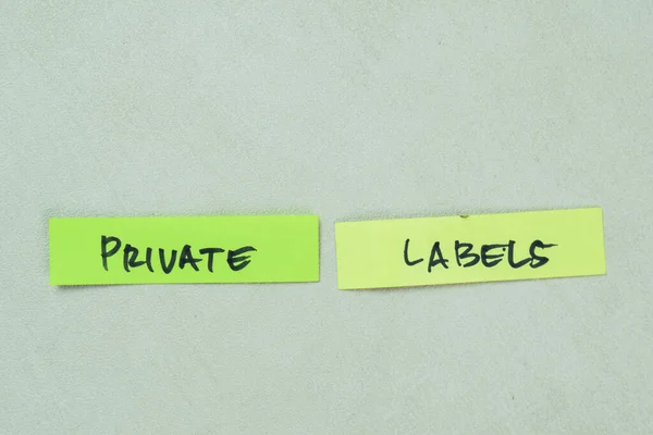 Concept of Private Labels write on sticky notes isolated on Wooden Table.