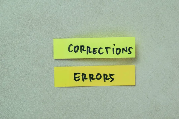 Concept of Corrections Errors write on sticky notes isolated on Wooden Table.