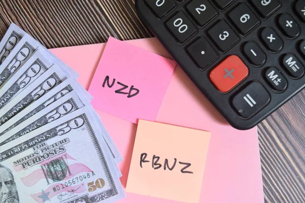 stock image Concept of NZD RBNZ write on sticky notes isolated on Wooden Table.