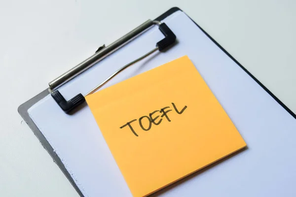 Concept of TOEFL - Test of English as a Foreign Language write on sticky notes isolated on white background.