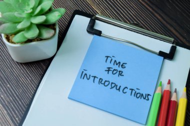 Concept of Time For Introductions write on sticky notes isolated on Wooden Table. clipart