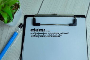 Concept of Definition of Ombudsman write on paperwork with a meaning isolated on wooden background. clipart