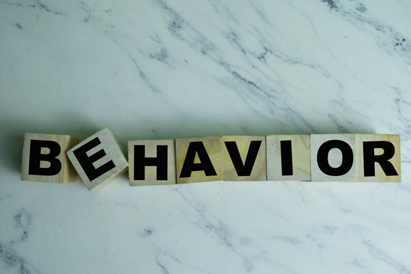Concept of The wooden Cubes with the word Behavior on wooden background.