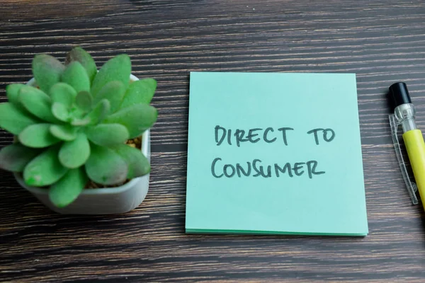 Concept of Direct To Consumer write on sticky notes isolated on Wooden Table.