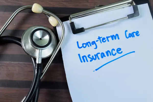 Concept of Long-term Care Insurance write on paperwork with stethoscope isolated on wooden background.