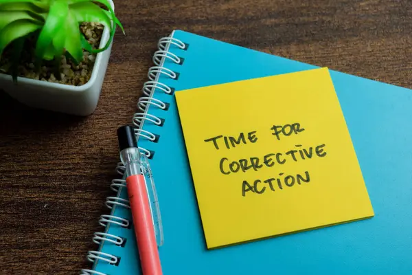 Concept of Time for Corrective Action write on sticky notes isolated on Wooden Table.