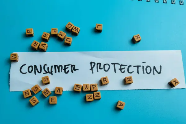 Concept of Consumer Protection write on sticky notes isolated on Wooden Table.