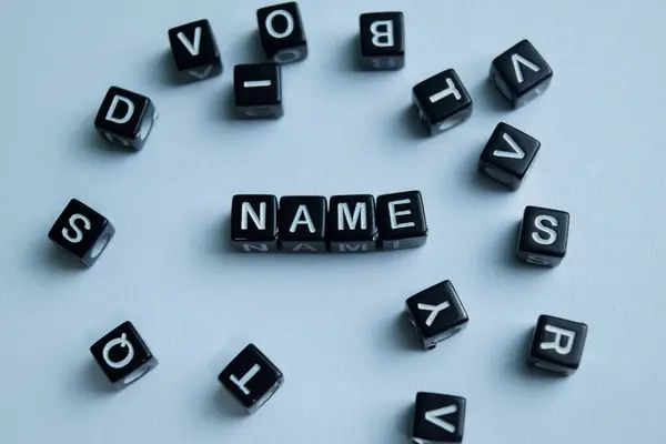 Stock image Concept of Name written on wooden blocks. Cross processed image on Wooden Background