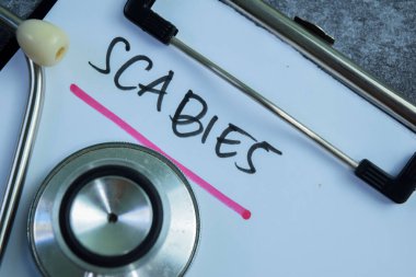 Concept of Scabies write on paperwork isolated on wooden background. clipart