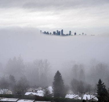 City in the sky. Foggy winter morning in Vancouver, Canada. clipart