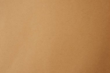 Kahverengi kağıt arka plan. Bej renkli karton desen. Duvar kağıdı. Koyu bej ambalaj kağıdı arka planı.