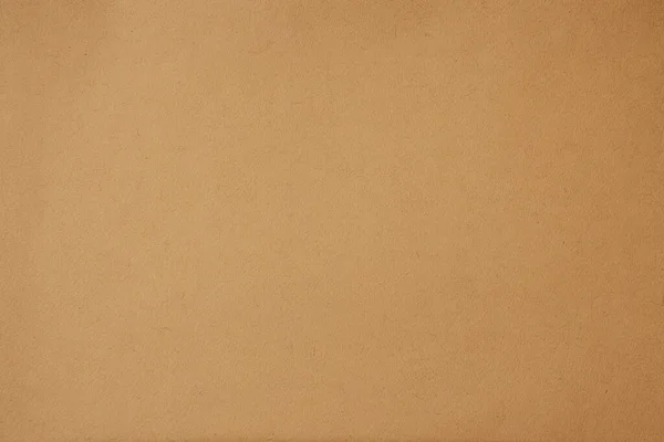 Brown paper background. Beige cardboard texture. Wallpaper. Dark beige wrapping paper background.