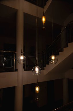 Chandeliers adorn the hall, crafted in the form of many hanging yellow and white balls. This combination of colors enhances the overall aesthetic of the room. clipart