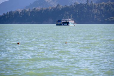 Tihri, Hindistan, 08 Aralık 2025: Göldeki bir mavnada yüzen bir otel, misafirlere su manzarası sunuyor. Bu eşsiz konaklama unutulmaz bir deneyim sunuyor..