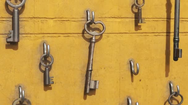 Verschiedene Schlüsselgrößen Und Schlüsselarten Hängen Haken Der Gelben Wand Eine — Stockvideo