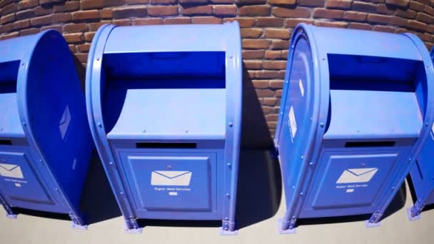 古いレンガの壁に対して無限の列に立っている青いメールボックス 晴れた晴れた天気 シームレスループアニメーション 郵便局は最悪の悪夢だった 人とのコミュニケーションの伝統的な方法 — ストック動画
