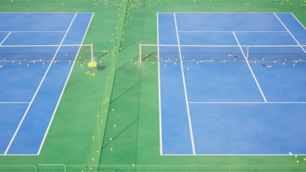 テニスコートのトレーニングの巨大な複合体 フロントパンニングビュー あなたのスキルを鍛え より良いプレーヤーになる 青と緑の表面 イエローボール 各裁判所は網の塀によって分けられます Hdについて — ストック動画