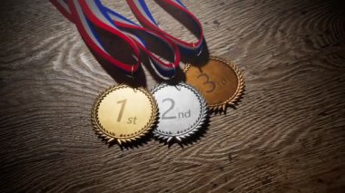 En çok kazanan üç kişi için bir dizi parlak Olimpiyat ödülü. Gümüş, altın, kurdeleli bronz spor madalyaları. Şampiyonlar için birincilik ödülü. Kazanma yarışmasının sembolü, başarı, zafer, şampiyonluk. Gurur.