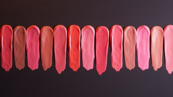 リップスティックはさまざまな色でウォッチします 美容室のための口紅サンプル 唇を華やかに見せる化粧品 ファッション関連のテーマに最適です クライアントのための選択 — ストック動画