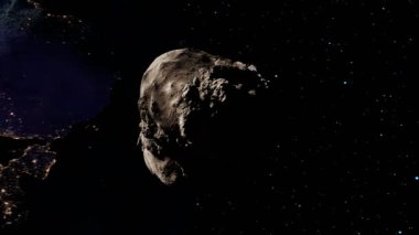 Asteroit arka planda yavaşça Dünya 'ya doğru yuvarlanıyor. Dünya 'ya yakın asteroit. Büyük kayalık katı kayanın yakın görüntüsü. Yıldızlararası seyahat eden bir taş. Astronomi ve astroloji. Meteor. Boşluk