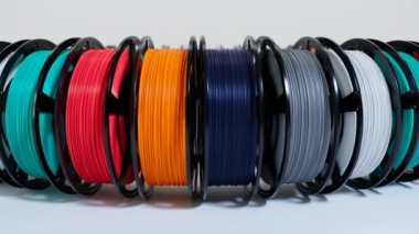 Çok renkli plastik iplik makaraları. 3D yazıcıya yazdırılıyor. 3D basım, farklı renkler, termoplastik iplik. Katkı teknolojisi. 3D yazıcı için dikenli tel plastik. Kusursuz döngü.