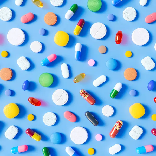 Countless Multi Colored Pills Capsules Tablets Scattered Light Blue Background — Stock Photo, Image