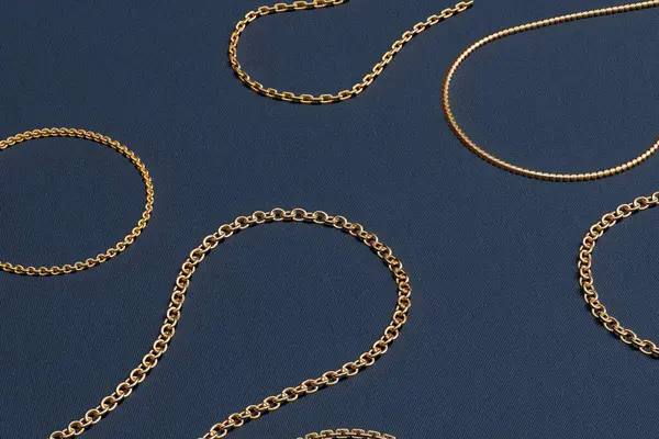 Golden chain collection. 3D rendering showcases a set of stunning, realistic golden necklaces in a variety of intricate designs. The necklaces are set against a bold blue background