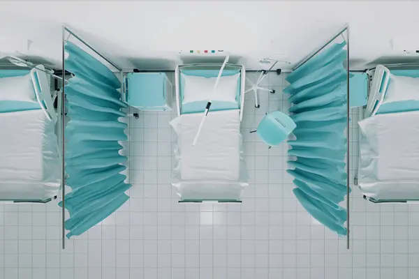 Medical beds at the hospital. Concept of intensive care beds for patients. The line of beds divided by a curtain. Clinic. Quarantine area. Infectious diseases. Covid-19. Coronavirus. Pandemic. Health