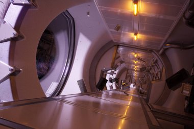 Karanlık fütürist uzay aracı koridoru. Sıfır yerçekimi boşluğunda yüzen sayısız nesne. Terk edilmiş istasyon. Renkli yıldızlar ve pencerelerin arkasında görünen nebula. Yüzen enkaz parçaları.